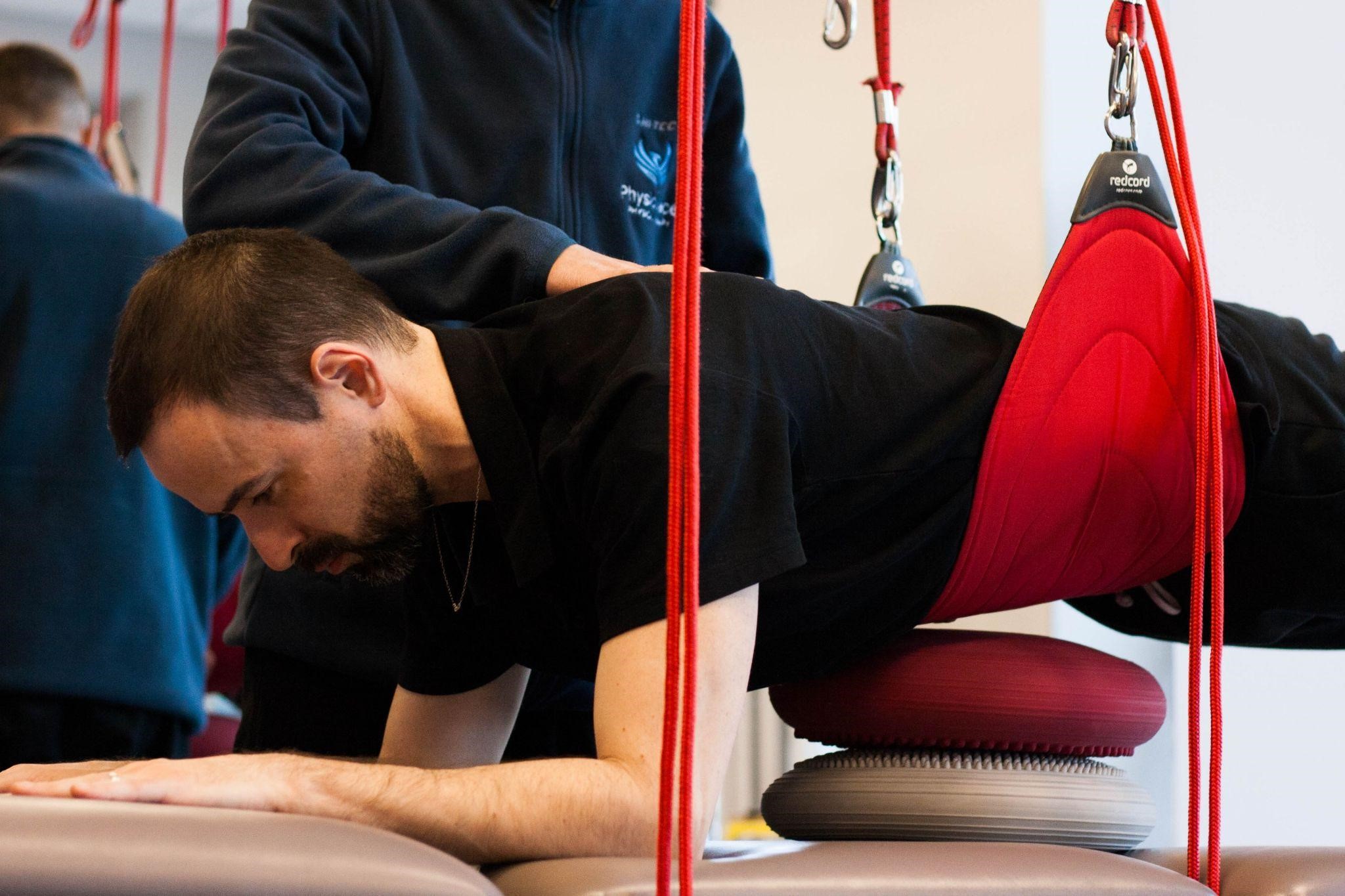 A man performs a deep muscle activation exercise using the Neurac method to improve mobility and reduce pain.